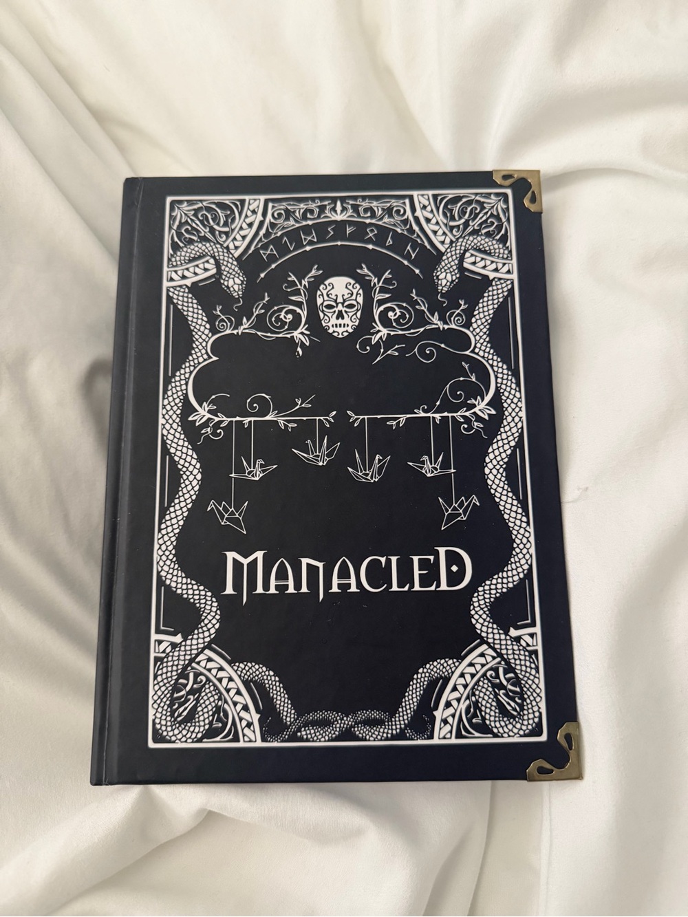 Manacled hardcover book; fan fiction; crane cover art